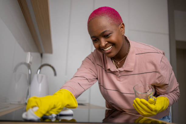 young woman cleaning her kitchen